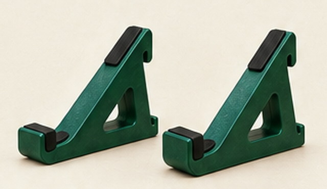 A pair of forest green single-tier stand wedges on a pale surface