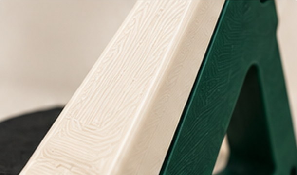 Close view of the printed texture along an ivory and green stand edge
