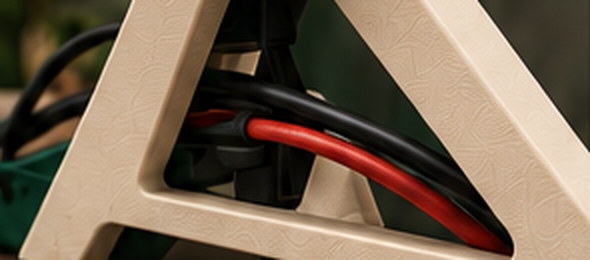 Patch and power cables running through the open frame of a stand