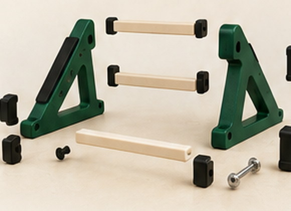 The separate printed parts of a stand laid out: two side frames, three braces, pads and a bolt