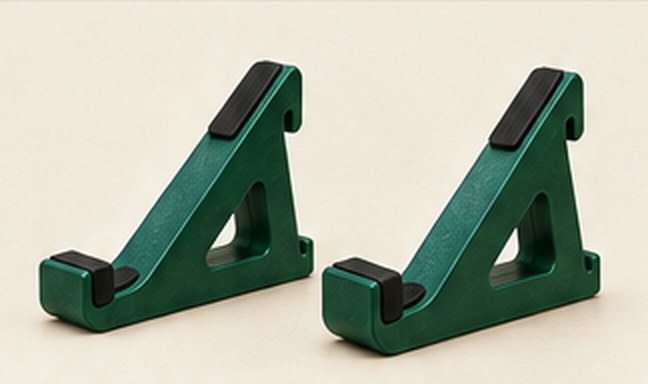 Two forest green single-tier stands on a pale surface
